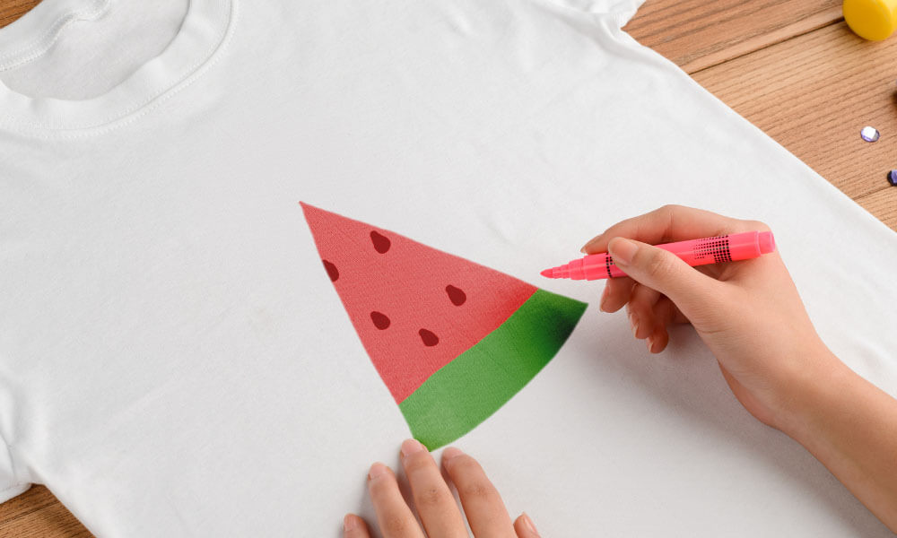 3 Methods Guests can Decorate Their Onesies 1. Fabric Markers, Paint, and Stencils This method gives your guest the ability to express themselves and create something a little more personal. Attendees can use fabric markers to freehand a design or write a special message to the baby or use a stencil and paint. 2. Iron-on Designs Add a pop of style with iron-on letters, numbers, and appliques to your decorating process. You can find iron-on transfers at any crafts store such as Michael’s and Joann’s. Be sure to show guests how to safely apply iron-on transfers to prevent anyone from being hurt during the process. Crafting Tip: Save money on crafting supplies by shopping at Dollar Tree. Dollar Tree has expanded its arts and crafting section to carry many of the same products found at big crafting stores. 3. Fabric Transfer Print Next is one of my favorite methods of personalizing a baby onesie. What better way to capture the fun than by having a photo printed onto the onesie? If you have a Wi-Fi or Bluetooth-enabled inkjet printer guests can simply connect and print their favorite photos onto fabric transfer paper. After the transfer has been printed, follow the same steps as the iron-on transfers, and voilà you have yourself a DIY custom-printed baby onesie.